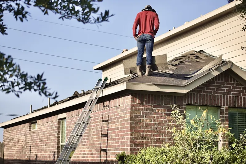Professional roofer working on a residential roof in Northeast Hazel Dell